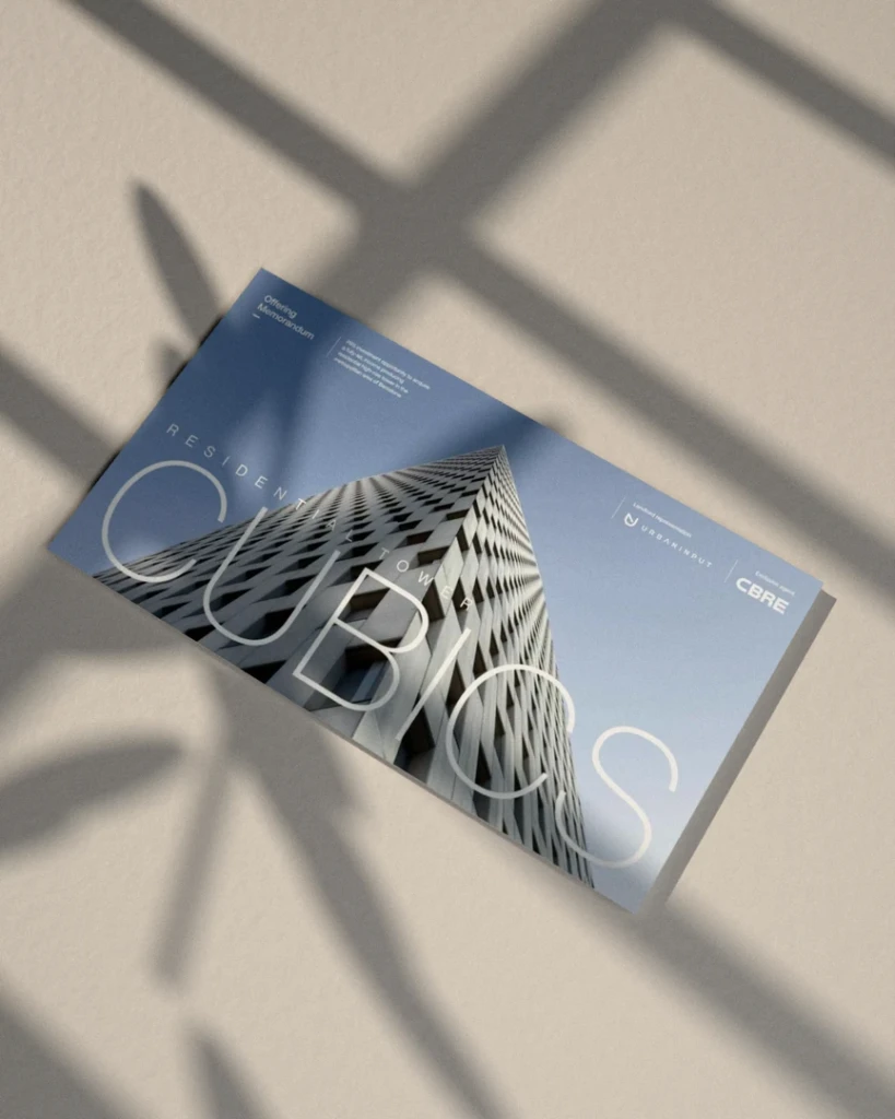 Visualisation: the cover of the Cubics Offering Memorandum for CBRE on a microcement table, in window light