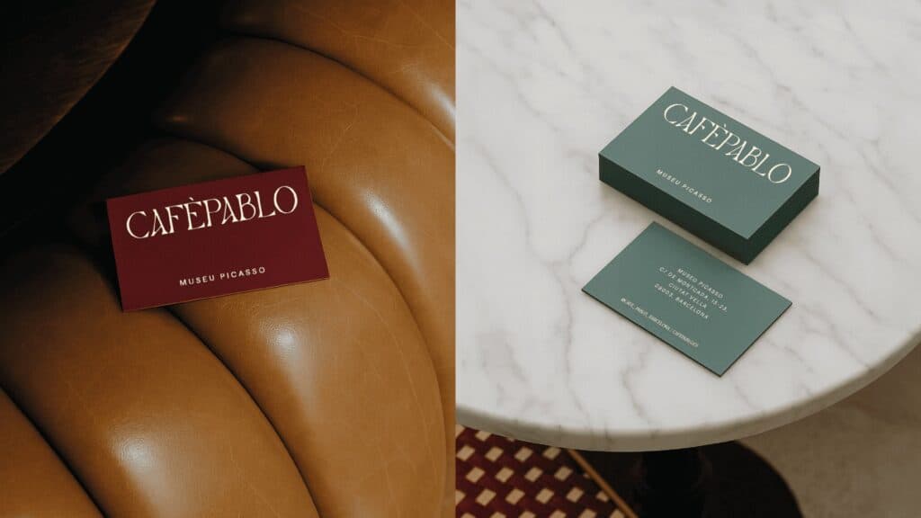 Tarjetas de Café Pablo en granate y verde sobre cuero y mármol