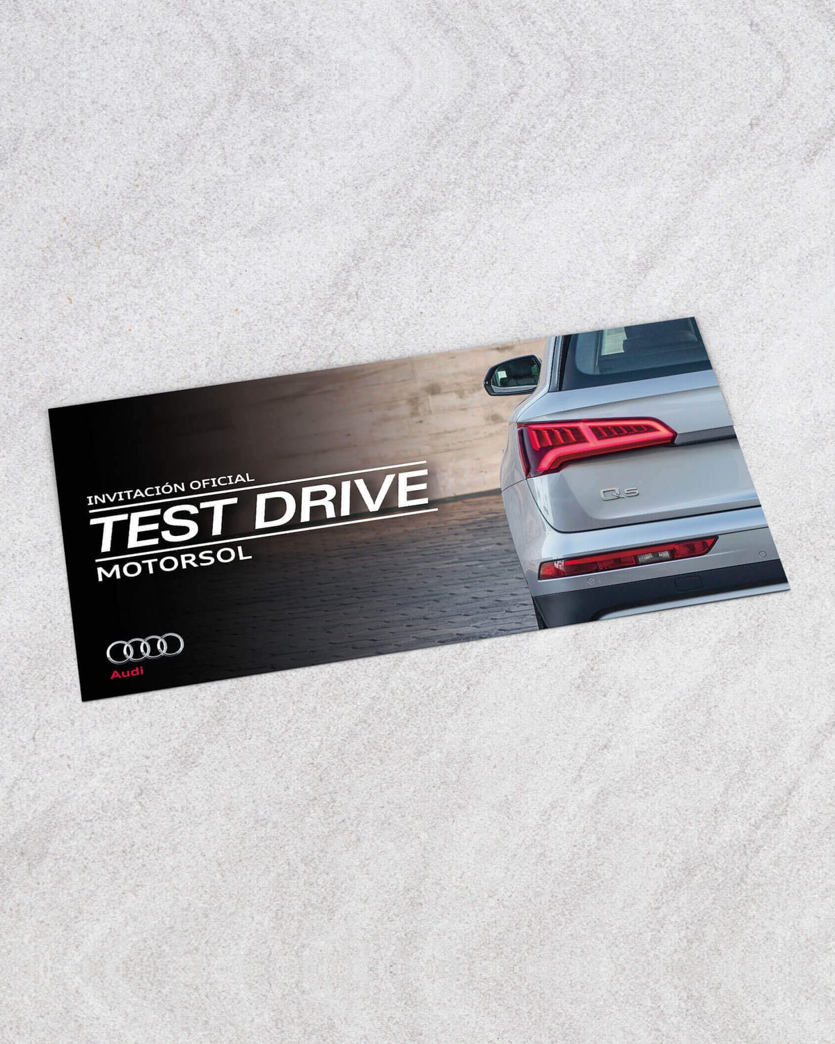 Invitación oficial al test drive del Audi Q5 de Motorsol, sobre piedra