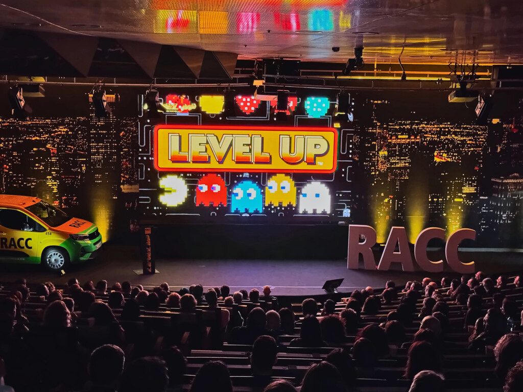 The Level Up title with video game characters on the stage screen at RACC’s 2026 sales meeting