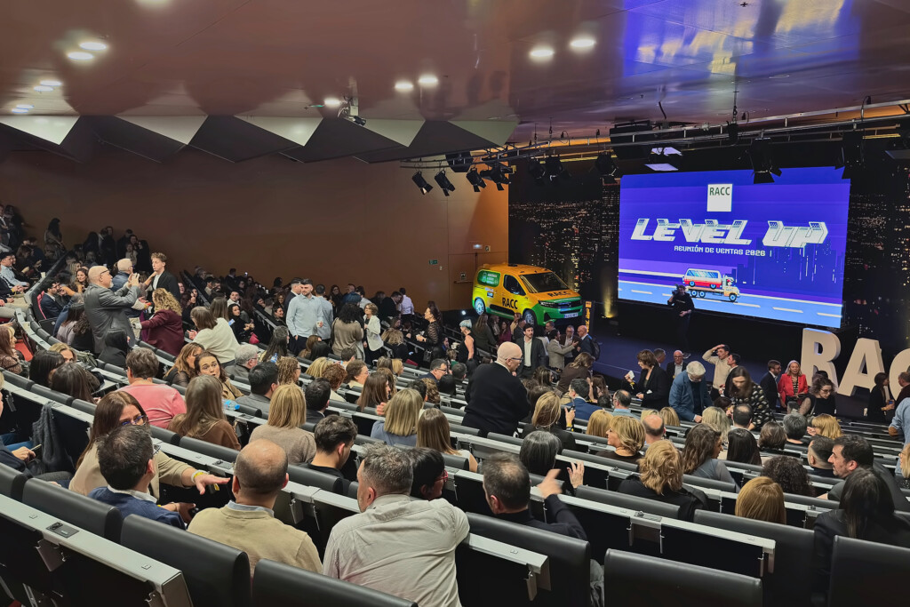 A full auditorium before the start of RACC’s 2026 sales meeting, with Level Up on screen