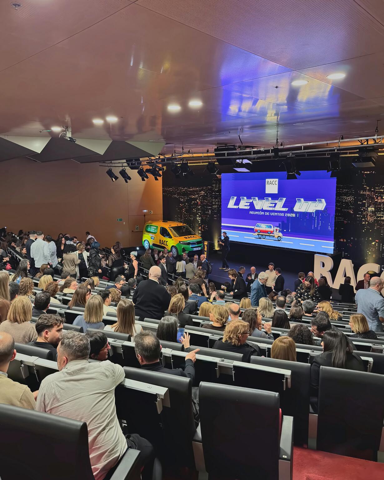 Attendees arriving at the auditorium in front of the Level Up screen at RACC’s 2026 sales meeting
