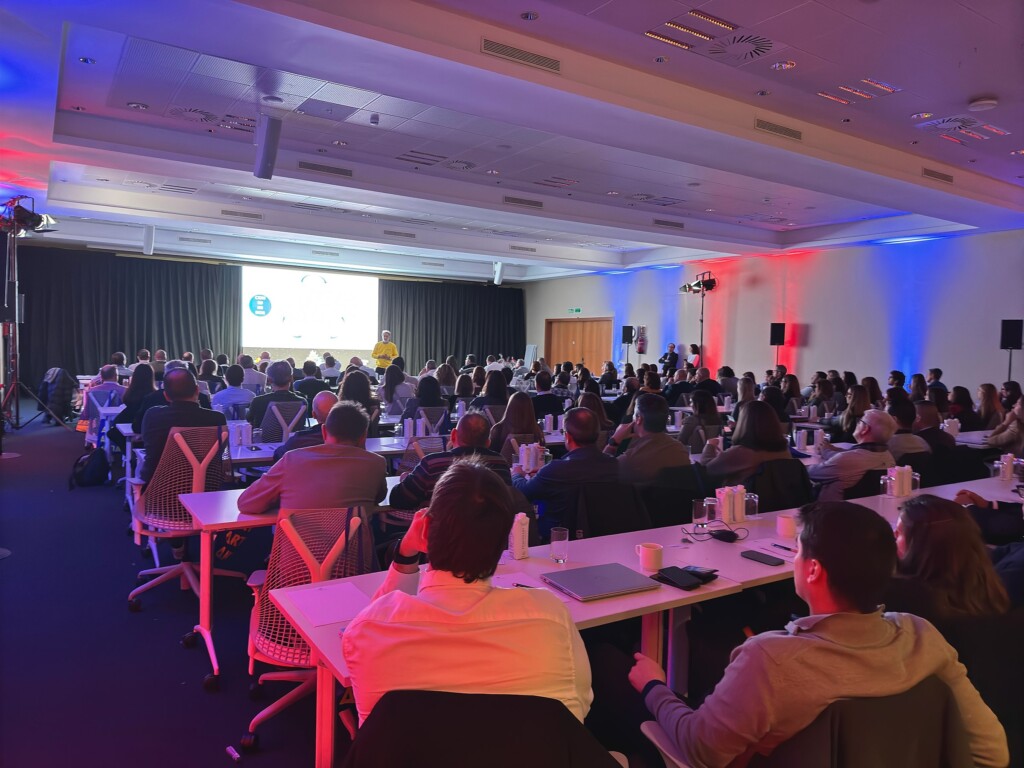 Side view of the room at the Adam Foods sales convention during a talk