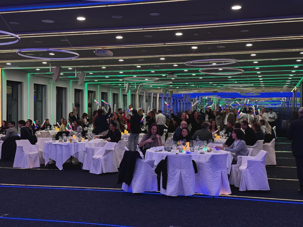 The gala dinner at the Adam Foods convention, with round tables and green and blue lighting
