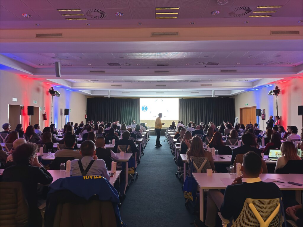 The central aisle of the plenary room at the Adam Foods convention, with work tables on both sides