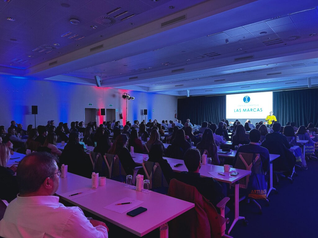 The plenary room at the Adam Foods sales convention in Sitges, lit in red and blue, with the entire sales network