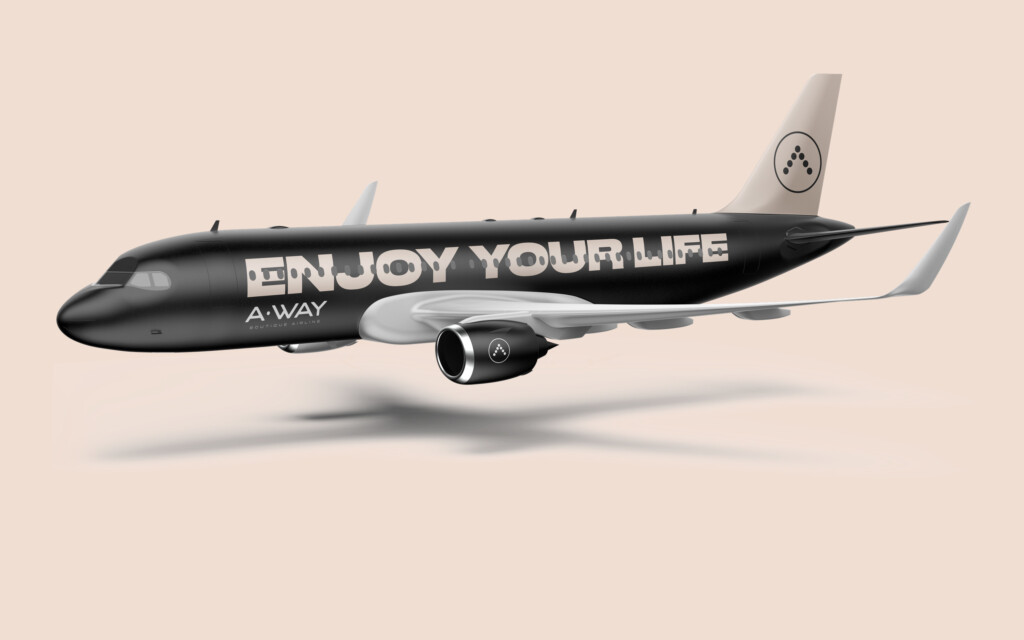 Airbus A320 con la librea negra de A·WAY y el lema Enjoy your life sobre fondo crema