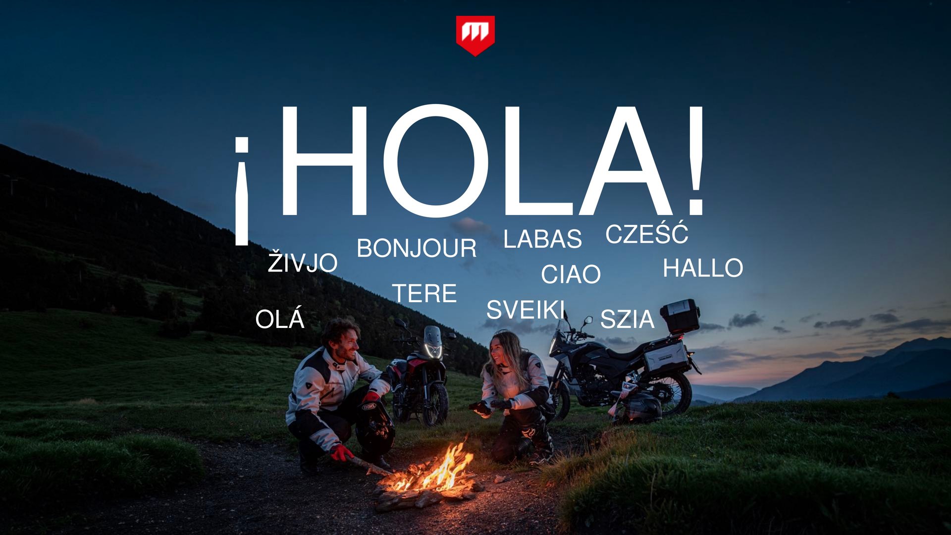 Slide from Macbor’s keynote for the international press: “¡Hola!” in several languages, with two riders by a campfire