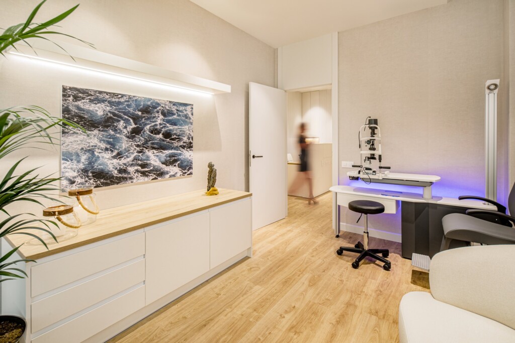 A consulting room with a slit lamp, a picture of the sea and natural light