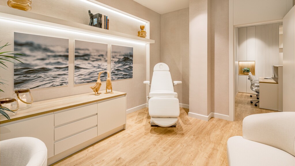 The treatment room at Clínica de la Mirada, with the sea triptych, the treatment couch and pale wood